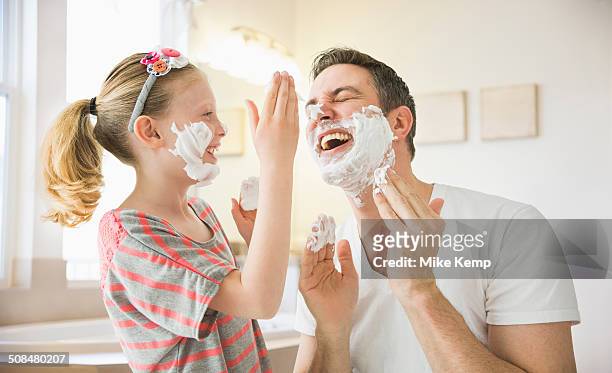 caucasian father and daughter playing with shaving cream - human body part stock-fotos und bilder