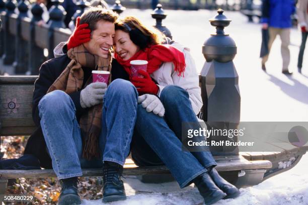 couple having coffee in urban park - mature couple winter outdoors stock pictures, royalty-free photos & images