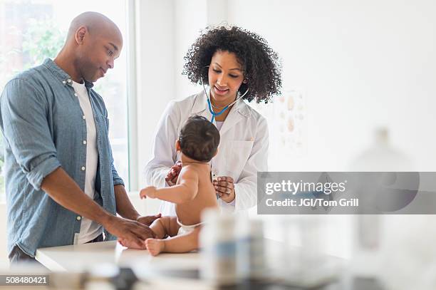 father and baby at doctor's office - strict parent stockfoto's en -beelden