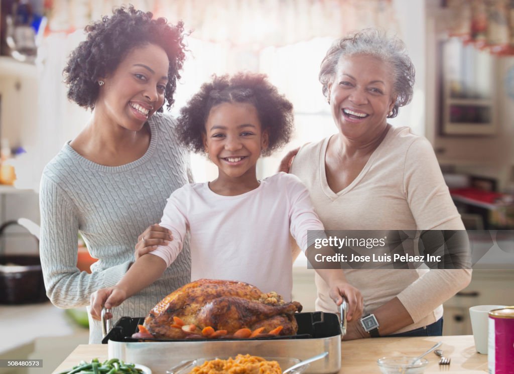 Three generations of women cooking together in kitchen
