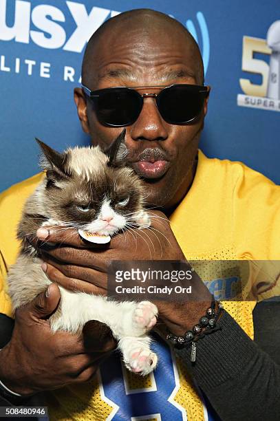 Former NFL player Terrell Owens and Grumpy Cat visit the SiriusXM set at Super Bowl 50 Radio Row at the Moscone Center on February 4, 2016 in San...