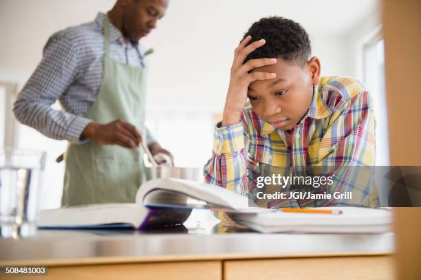 frustrated boy doing homework - homework frustration stock pictures, royalty-free photos & images