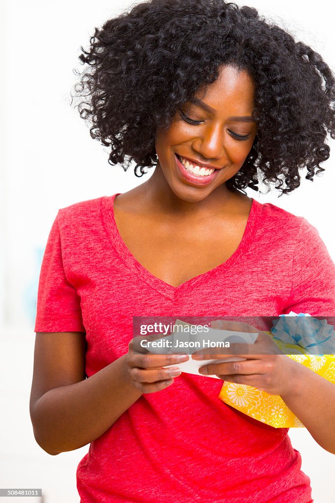 Mixed race woman reading birthday card