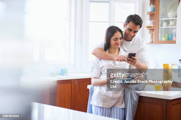 indian couple eating breakfast in kitchen - indian couple at home imagens e fotografias de stock