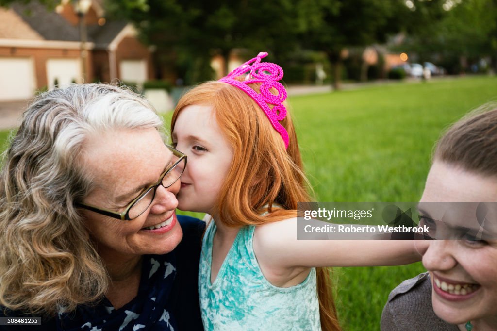 Three generations of Caucasian women sitting in park