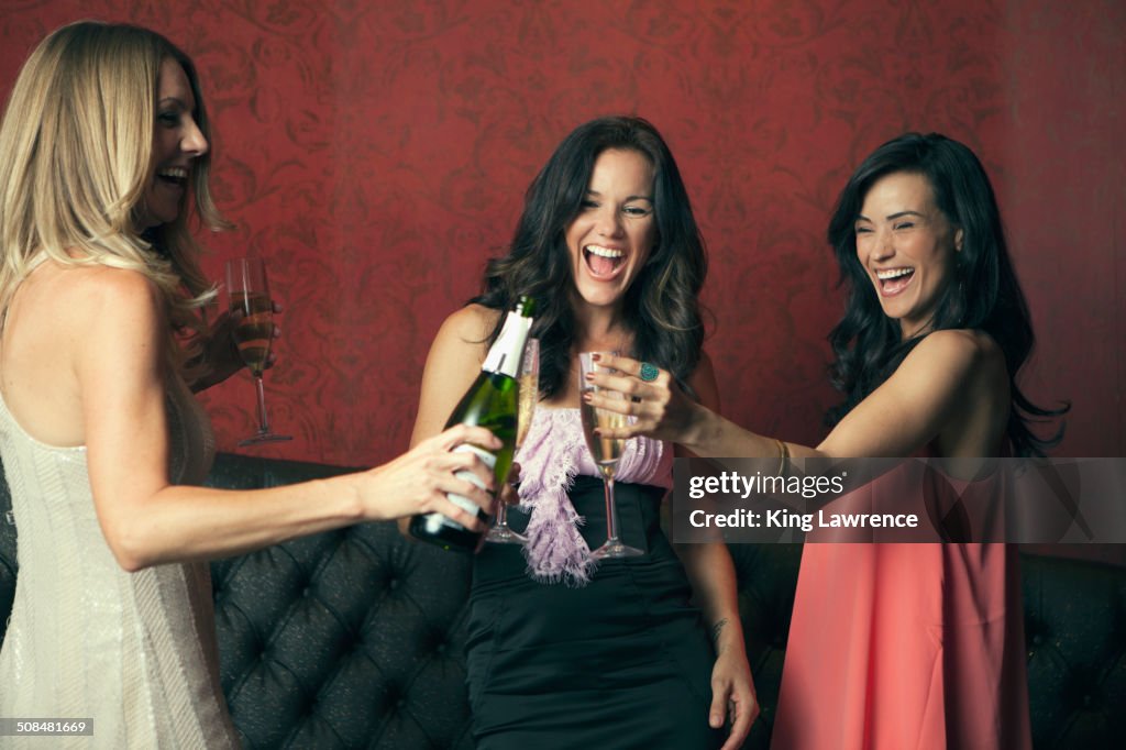 Women toasting with champagne in nightclub