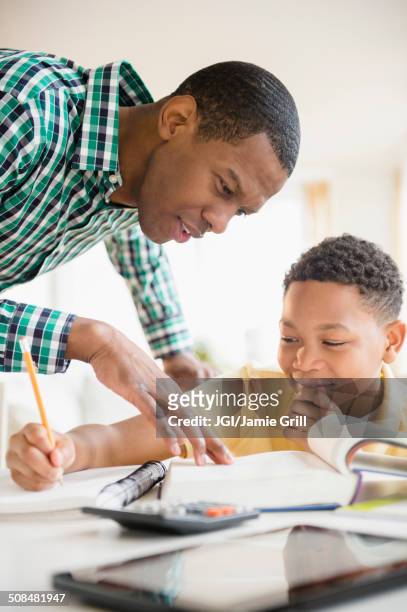 father helping son with homework - math homework stock pictures, royalty-free photos & images