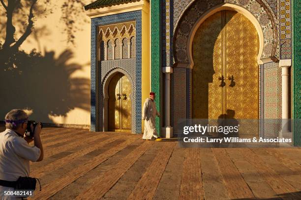 caucasian man taking picture of man by ornate temple - fez morocco stock pictures, royalty-free photos & images