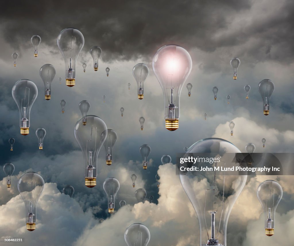 Light bulbs floating in clouds