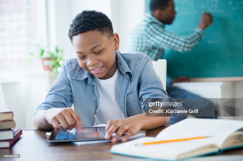 Student using tablet computer in classroom
