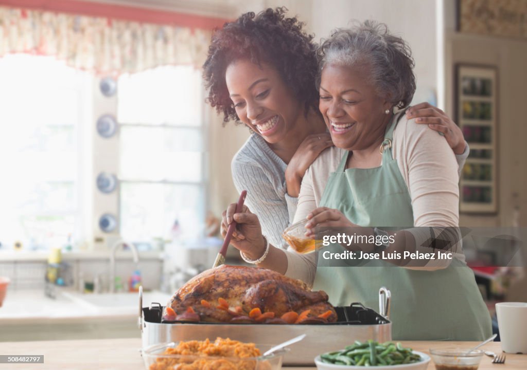 Mother and daughter cooking together in kitchen
