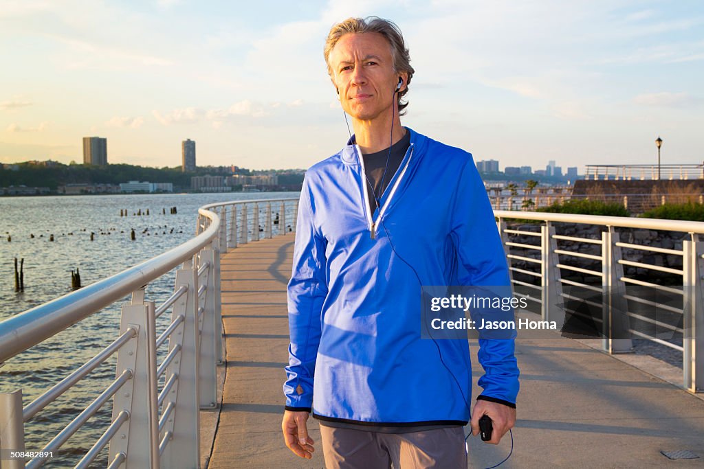 Caucasian man standing at urban waterfront