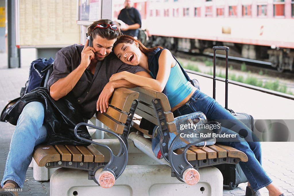 Couple relaxing at train station