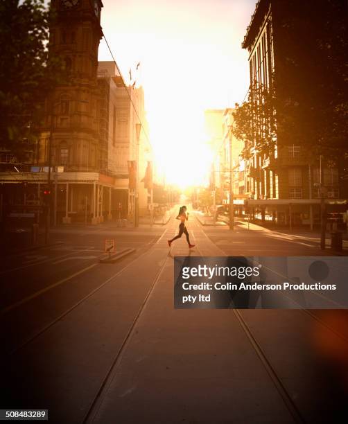 pacific islander woman jogging at sunset - athletics australia stock-fotos und bilder
