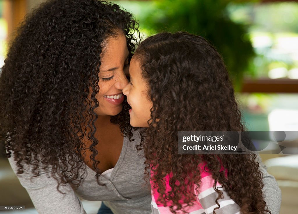 Mother and daughter touching noses