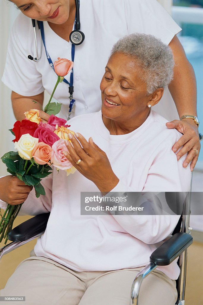 Senior patient getting flowers in hospital