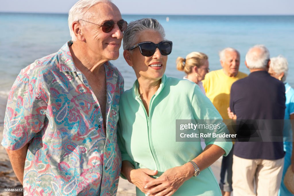 Senior couples walking on beach