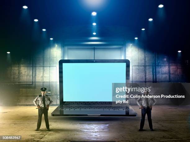 security officers guarding laptop computer - password strength stock pictures, royalty-free photos & images