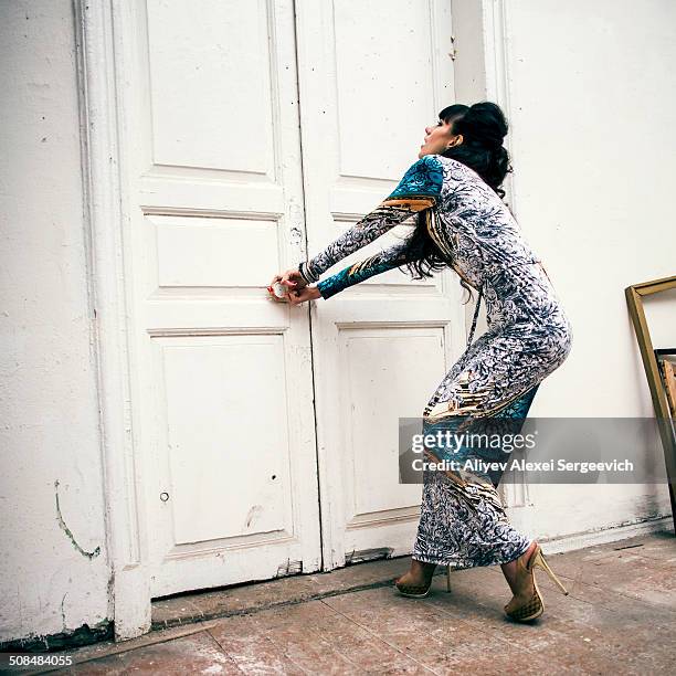 caucasian woman trying to open locked door - stuck door stock pictures, royalty-free photos & images