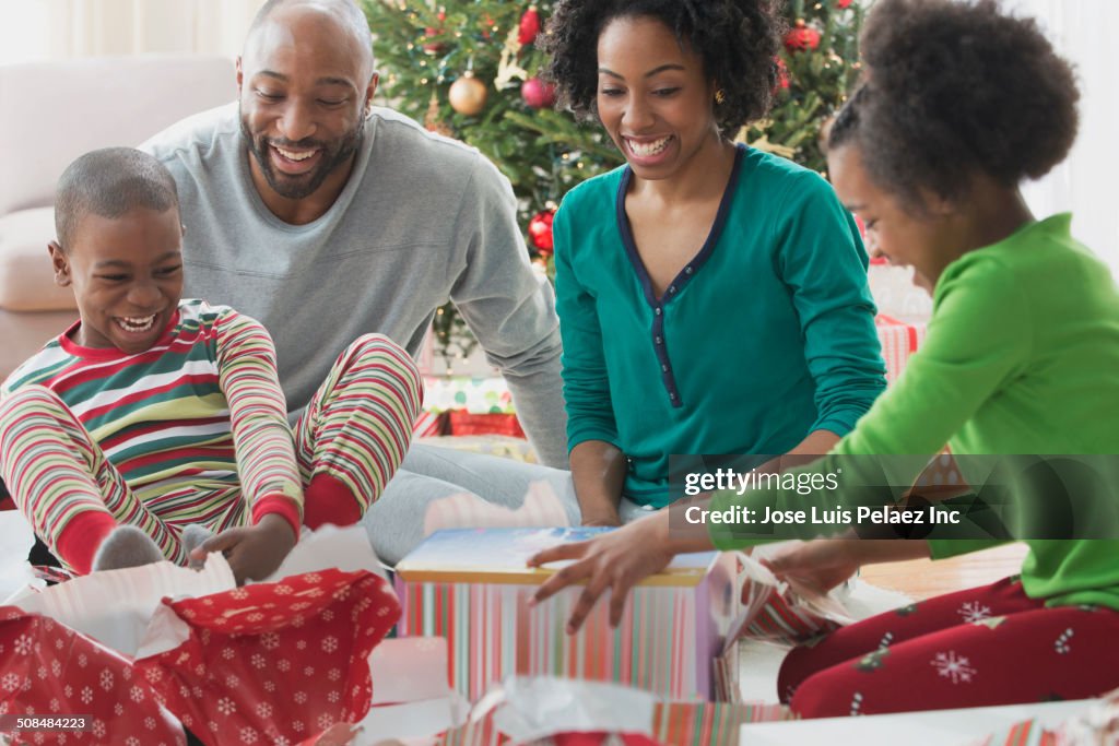 Family opening Christmas presents together