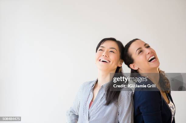 women laughing together - females laughing stock pictures, royalty-free photos & images