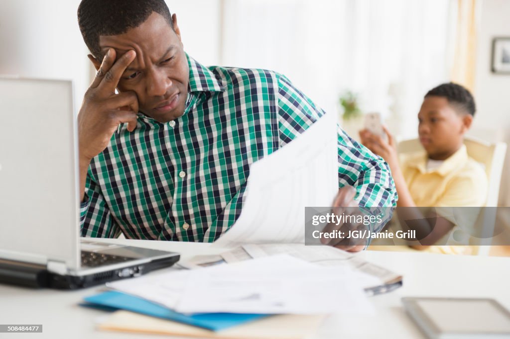 Anxious father paying bills online