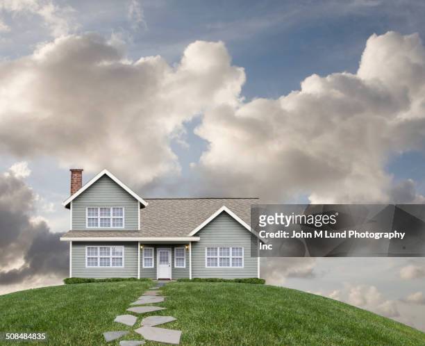 house on grassy hill - hill stock pictures, royalty-free photos & images