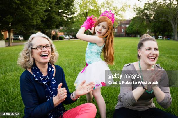 three generations of caucasian women relaxing in park - parents cheering stock pictures, royalty-free photos & images