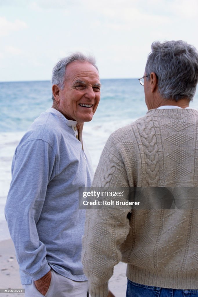 Caucasian father and son walking on beach