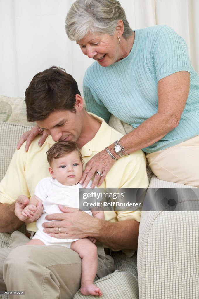 Three generations of family on sofa