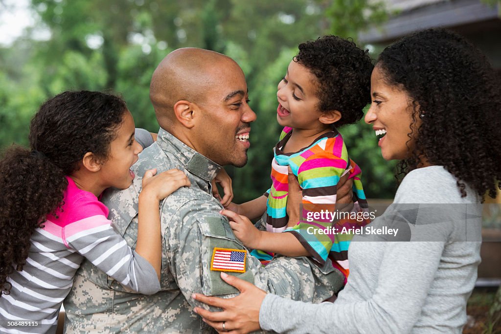 Mother and children greeting soldier