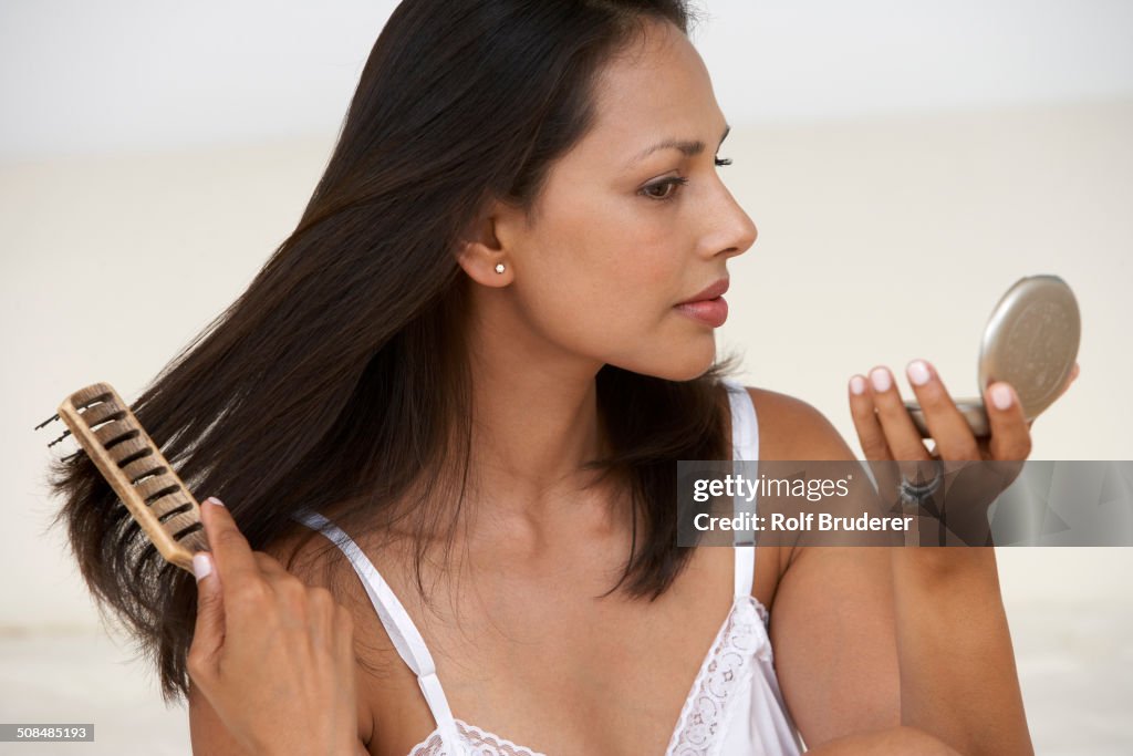 Indian woman brushing her hair