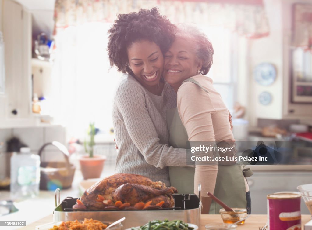 Mother and daughter cooking together in kitchen