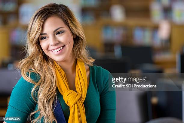 pretty high school or college student in library - beautiful college girls stock pictures, royalty-free photos & images
