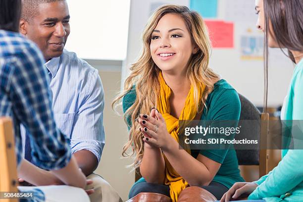 hispanic teenage girl speaks to counselor in support group - mental alertness stock pictures, royalty-free photos & images