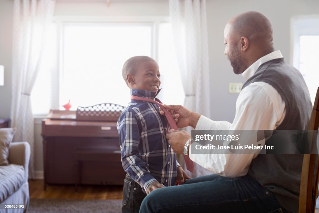 Father tying son's tie