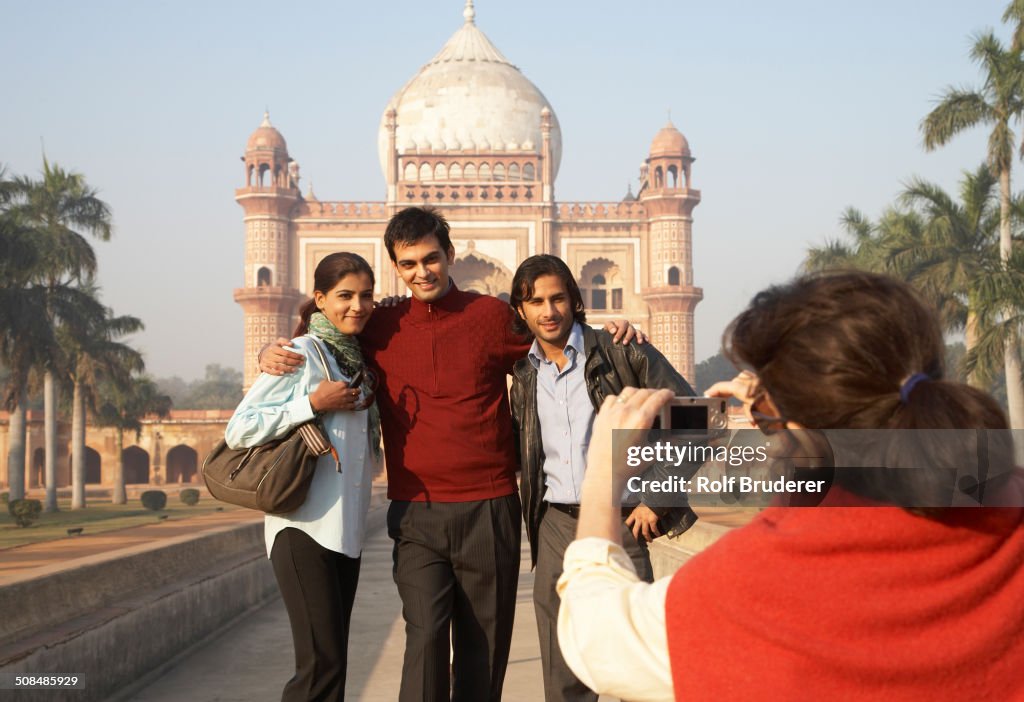 Indian family taking pictures by Safdarjang's Tomb, Delhi, India