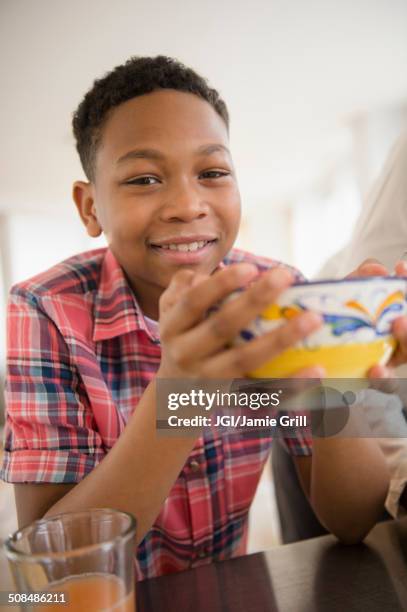 black boy eating breakfast in kitchen - 13 year old cute boys stock pictures, royalty-free photos & images
