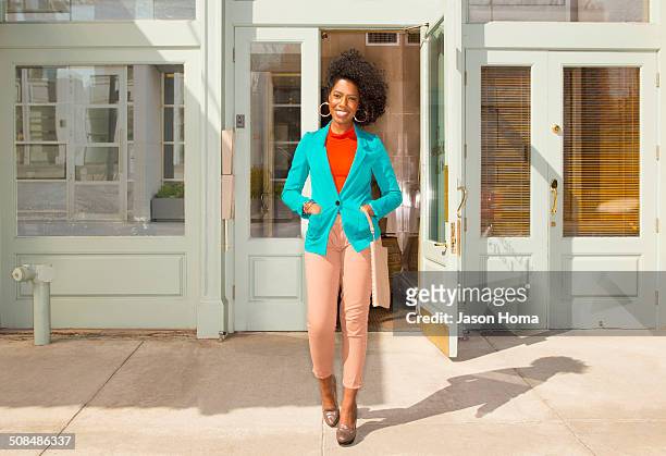 mixed race woman standing on city sidewalk - afro caribbean and american stock-fotos und bilder