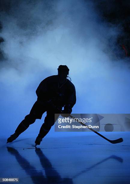 Player skates through the smoke during introductions prior to game one of the Western Conference quarterfinal series of the 2004 Stanley Cup Playoffs...