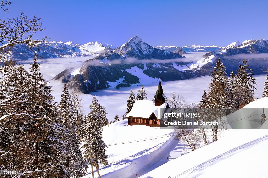 Chapel in winter with view on the Hochflue and the Central Swiss Alps, Haggenegg, Canton of Schwyz, Switzerland