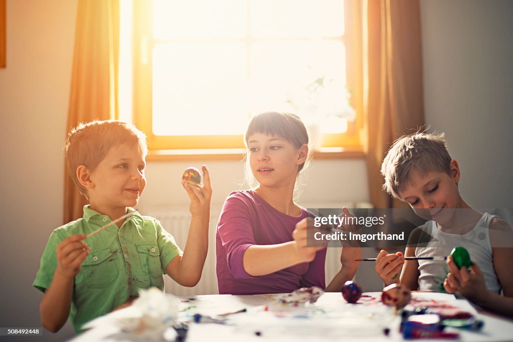 Kids painting easter eggs