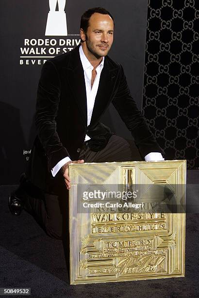 Designer Tom Ford poses with his plaque for the 'Rodeo Walk of Style' Award on Rodeo Drive March 28, 2004 in Beverly Hills, California.