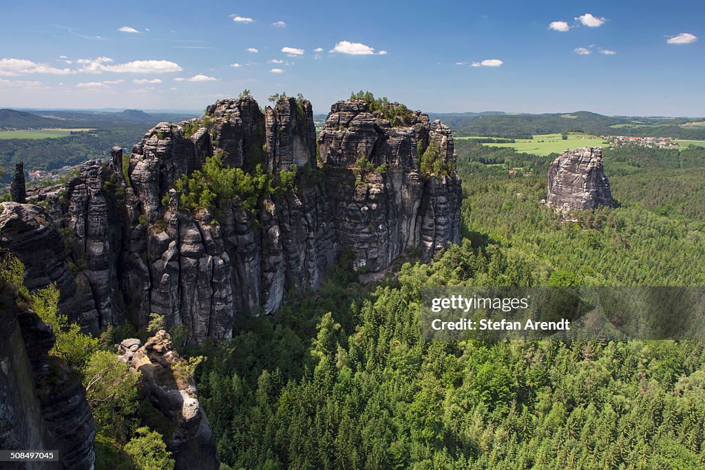 View of Schrammsteine ridge, jagged rock formation and Falkenstein rock, Elbe Sandstone Mountains, Saxony, Germany, Europe