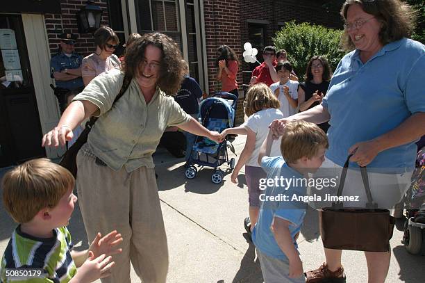 Lauri Meade and her partner of 16 years, Christine Young , and their children, from left, Reed Madison and Zachary celebrate outside the City Clerk's...