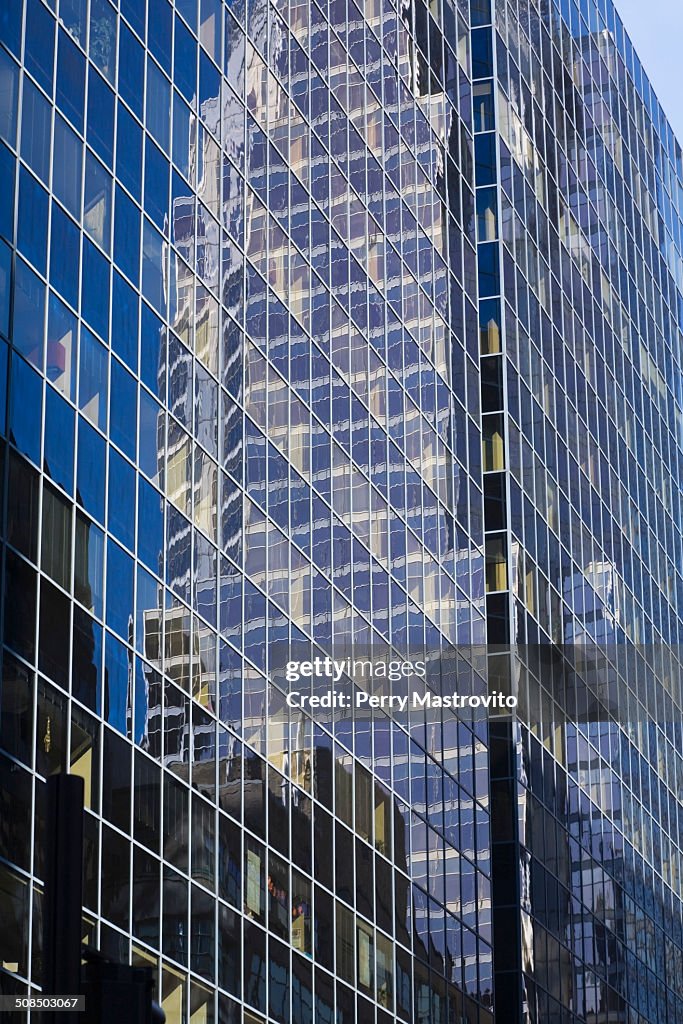 Reflections in a modern glass and steel office tower building, Montreal, Quebec, Canada