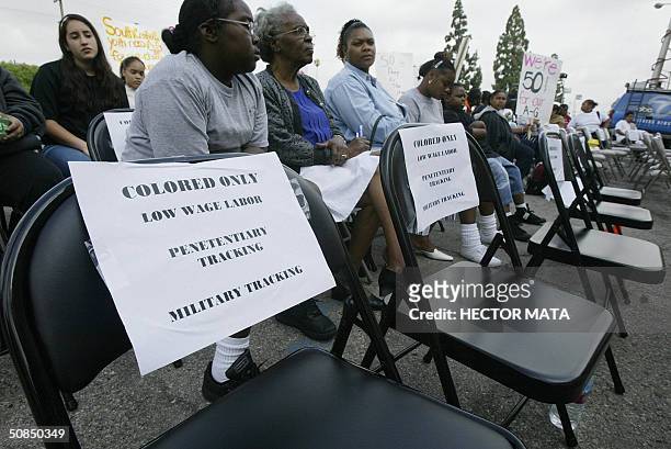 Signs are posted in seats signifying continuing segregation between white and black and brown students during a demonstration for equal access to...