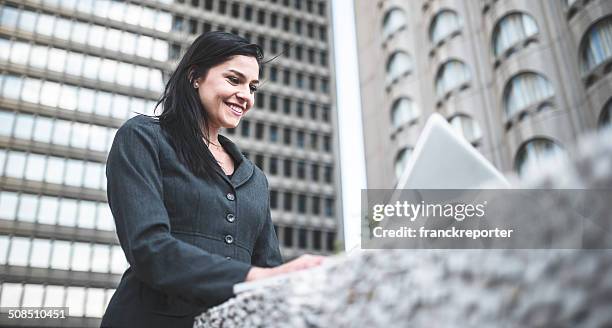 business woman working on a laptop on the downtown - montreal downtown stock pictures, royalty-free photos & images