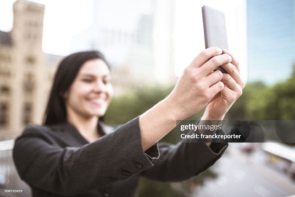 Business woman take a selfie on the city