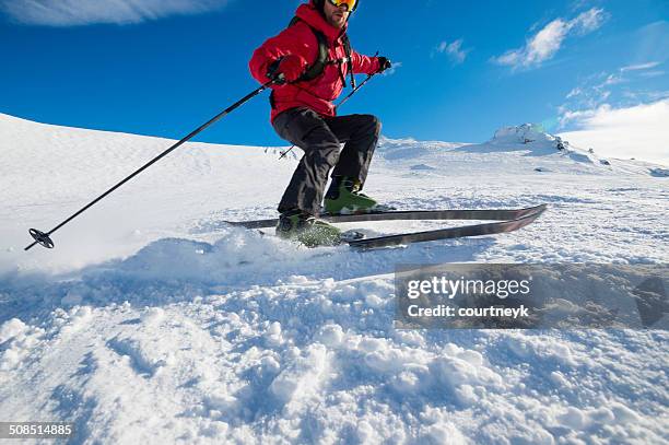 skier turning on a blue sky day - ski new zealand stock pictures, royalty-free photos & images